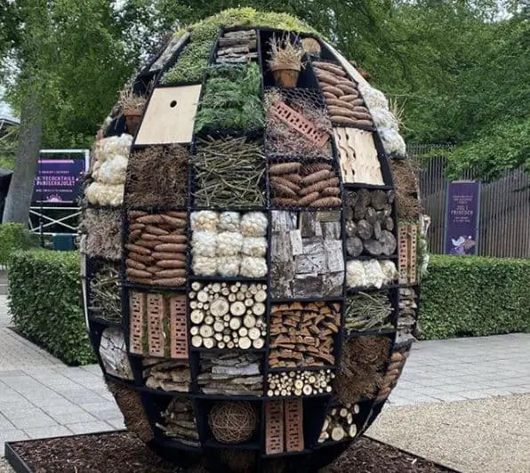 a-giant-egg-shaped-insect-hotel-with-many-compartments-filled-with-different-garden-materials